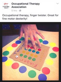 a child's hand on top of a cardboard board with colorful circles and dots