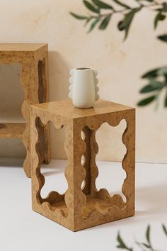 two wooden cubes with one candle holder on each side and the other in front