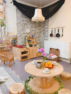 a table with plates and bowls on it in the middle of a room filled with furniture