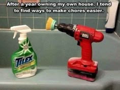 a red and white spray bottle sitting on top of a bath tub next to a cleaning brush