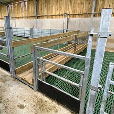 the inside of a building with green flooring and metal railings on each side