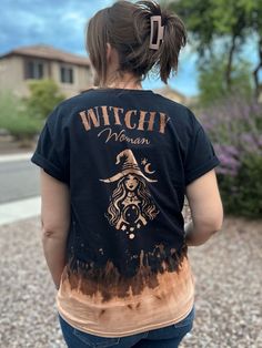 Embrace the mystical vibes with this one-of-a-kind Witchy Woman T-Shirt. Handmade with care, each shirt features a unique bleached pattern, making it truly special. The spooky design captures the essence of the fall season, perfect for witches and magic enthusiasts. Whether you're casting spells or sipping pumpkin spice lattes, this shirt is a must-have for your witchy wardrobe! Mystical Cotton Crew Neck T-shirt, Bleached Crew Neck T-shirt For Festival, Halloween Festival Cotton T-shirt, Festival Bleached Crew Neck T-shirt, Cotton Halloween Festival T-shirt, Halloween Cotton T-shirt For Festivals, Mystical Style Cotton Crew Neck T-shirt, Mystical Crew Neck Cotton T-shirt, Mystical Style Cotton T-shirt With Crew Neck