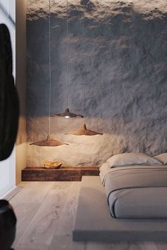 a bed sitting in a bedroom next to a wall covered in snow and hanging lights