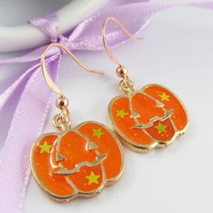 Cute Halloween Jack-o-lantern Charm Hook Earrings       Materials:     Earring Hooks - Copper   Charms - Alloy & Resin      Approx. Total Earring Length:  35mm Novelty Orange Earrings For Halloween, Nickel Free Earrings For Halloween Party, Nickel-free Earrings For Halloween Party, Nickel Free Halloween Party Earrings, Nickel-free Halloween Party Earrings, Orange Dangle Earrings For Halloween, Novelty Pierced Earrings For Halloween, Novelty Halloween Pierced Earrings, Orange Novelty Halloween Jewelry