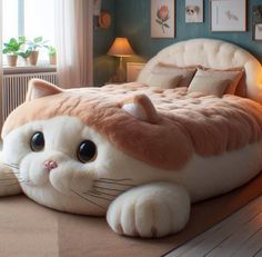 a cat shaped bed in the middle of a room