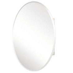 a white round mirror sitting on top of a wall