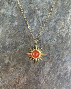 This necklace is handmade with a 19mm by 21mm 14k gold-plated stainless steel pendant and a 6mm genuine sunstone cabochon. The chain is 14k gold-filled and will not tarnish.  This necklace is hypoallergenic. (Cadium free, lead free, and nickel safe) Sunstone is an empowering crystal that promotes optimism and confidence. Please note that each stone is unique and varies in color.  Each necklace comes in a ribbon-wrapped box, ready to be gifted. If you would like to leave a note for the recipient, Handmade Gold Charm Necklaces With Star Shape, Gold Star Charm Necklace Handmade, Handmade Gold Star Charm Necklaces, Handmade Gold Star Charm Necklace, Handmade Gold Star Necklace, Handmade Star-shaped Gold Necklace, Gold Starburst Necklace For Gift, Gold Spiritual Necklace With Cabochon, Spiritual Gold Necklace With Cabochon