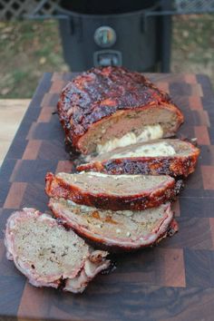 sliced meat sitting on top of a wooden cutting board