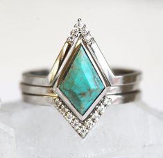 an image of two rings with turquoise stones on them and diamonds around the band,