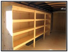 the inside of a storage room with wooden shelves