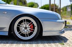 a silver sports car parked on top of a parking lot