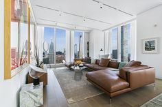 a living room filled with furniture and tall windows