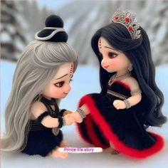 two dolls sitting next to each other in the snow with tiara on their heads