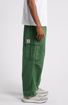 Stay comfy in these cargo pants cut from durable organic-cotton twill with roomy pleats at the waist and knees for ease of movement. 27 1/2" inseam; 19" leg opening; 13" front rise; 15 1/2" back rise (size 32) Zip fly with button closure Front slant pockets; cargo flap-patch pockets; back flap pockets 100% organic cotton Machine wash, tumble dry Imported Male Fashion Fall 2024, Midwestern Mens Fashion, Work Clothes Men Construction, Men’s Cargo Pants Styles, Green Cargo Pants Outfit Fall, Men’s Fall Fashion 2024, Funky Outfits Men, Maine Outfits, Mens Minimalist Wardrobe