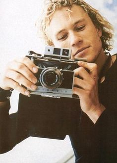 a man taking a photo with an old camera