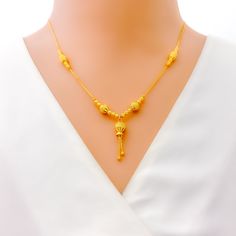 This dressy 22k gold necklace features a stunning beaded design, adding a touch of elegance and sophistication to any outfit. Weighing 9.6 grams, it offers a luxurious yet comfortable feel. The radiant yellow gold finish enhances its opulent appeal. With a necklace length of 18.5 inches and a drop length of 1 inch, this piece is perfect for making a stylish statement. The secure lobster lock ensures confident and comfortable wear. Elevate your jewelry collection with this exquisitely crafted beaded necklace, ideal for bringing a touch of dressy elegance to both everyday and special occasions. PRODUCT DETAILS Gold Purity(karat): 22k Gold Weight(grams): 9.6 Item Finish: Yellow Gold Necklace Length: 18.5" Drop Length: 1" Lock Style: Lobster Lock Elegant 22k Gold Beaded Necklace, 22k Gold Yellow Necklace For Wedding, Festive 22k Yellow Gold Necklace, Formal Gold-plated Yellow Gold Temple Necklace, Yellow 22k Gold Pendant Necklace, 22k Gold Necklace, Bridal Jewelry Necklace, Precious Stones Rings, Diamond Pendant Sets