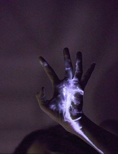 a person's hand is covered in white light