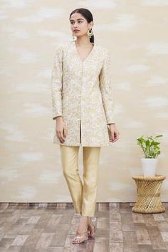 Beige dupion silk panelled achkan jacket style  kurta with floral thread work embroidery all-over. Paired with beige trouser.
Components:2
Embroidered
Neckline:V-Neck
Sleeve Length:Full
Fabric:Dupion Silk
Color:Beige
Front closure kurta
Side slit kurta - Aza Fashions Beige Trouser, V Neck Kurta, Pant For Women, Dupion Silk, Embroidered Neckline, Kurta With Pants, Silk Embroidery, Thread Work, Embroidered Silk