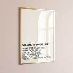 a mirror hanging on the wall in front of a window with a poem written below it