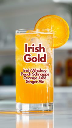 an orange slice is sitting on the edge of a glass with irish gold in it