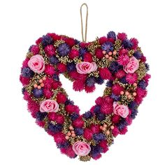 a heart shaped wreath with pink and purple flowers