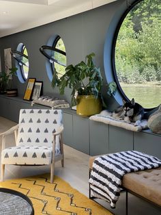 a living room filled with furniture and lots of windows