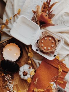 an assortment of food and candles on a bed