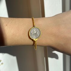 24KT yellow gold-plated + sterling silver replica Roman coin bangle with diamond. Double-sided silver coin set with textured, matte finish to the gold bangle! Length: 7" approx. Diameter: 60mm Band width: 2mm Weight: 11.80 grams (1) .01 CT natural, round diamond 21mm round replica coin Hook style clasp 925 sterling silver purity with 24KT gold plating Adjustable Engraved Gold Bracelet, Engraved Adjustable Gold Bracelet, Luxury Silver Brass Bangle, Gold Tarnish-resistant Round Bangle, Adjustable Tarnish Resistant Bangle, Engraved Gold-plated Round Bracelet, Engraved Round Gold-plated Bracelet, Engraved Gold-plated Bracelet, Etched Round Gold Bracelet Gift