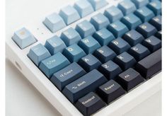 a computer keyboard sitting on top of a white table