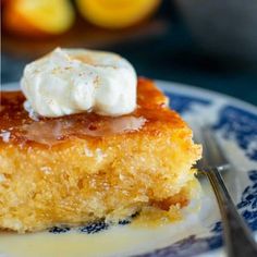 a piece of cake sitting on top of a blue and white plate next to a fork