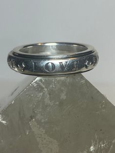 "Hope Faith ring spinner band peace love sterling silver women Size 7.75 Between a size 7.75 and a size 8 Weight 9.1g Width. 3/16\" Free Shipping & Free Postal Insurance Delivered in a Gift Box If you do not want the ring polished and want to leave the natural patina please let me know at the time of purchase as I do polish rings before I ship rings out. Thanks Free First Class shipping and postal insurance is included. If you want to upgrade to priority kindly pay an additional fee to do so. Th Adjustable Sterling Silver Promise Ring, Adjustable Hand Stamped Engraved Ring, Symbolic Adjustable Stackable Rings For Anniversary, Adjustable Engraved Ring Stamped 925 For Anniversary, Adjustable Stamped Engraved Ring With Round Band, Adjustable Stamped 925 Engraved Ring For Anniversary, Adjustable Silver Engraved Ring, Spiritual Style, Adjustable White Gold Engraved Ring With Stamped Details, Adjustable Spiritual Sterling Silver Engraved Ring