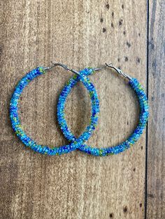 A pair of hoop earrings made with limited edition multicolor silver lined seed beads in oceanic colors. Comes in one of five sizes!  30mm (1 inch) 40mm (1.5 inch) 50mm (2 inch) 60mm (2.5 inch) 70mm (3 inch) These one of a kind earrings are fantastic for raves, night clubs, parties, summer vacations, festivals or just for a pop of color in your wardrobe.  Made with a spring clasp for ease. Hypoallergenic professional grade metals, none of the cheap stuff used here! Want another size or have somet Cheap Stuff, Boho Hoop Earrings, Mermaid Lagoon, Night Clubs, Summer Vacations, Silver Line, Jewelry Earrings Hoops, Night Club, Beaded Earrings