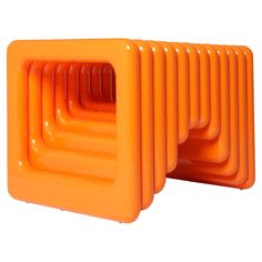 an orange plastic object with four sections stacked on top of each other, in the shape of a rectangle