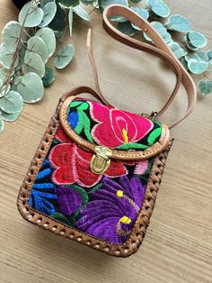 This one of a kind leather bags features an embroidered vibrant design. It is sure to add color & joy to your life! The bag includes an adjustable removable strap and a zipper to keep your belongings secure. It is made from 100% leather. All items are made with love by talented skilled artisans. Because of the handmade nature of the items, they may have some imperfections. However, this is what makes them one of a kind! **Listing is for 1 leather bag** Rectangular Leather Bag With Floral Embroidery, Leather Bag With Floral Embroidery And Rectangular Shape, Hand-stitched Leather Shoulder Bag Gift, Artisan Hand Painted Bags For Gifts, Artisan Hand-stitched Bag As Gift, Embroidered Leather Rectangular Shoulder Bag, Leather Bag With Multicolor Embroidery For Everyday Use, Leather Shoulder Bag With Floral Embroidery For Daily Use, Multicolor Hand Tooled Travel Bags