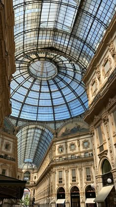 the inside of a shopping mall with glass ceiling