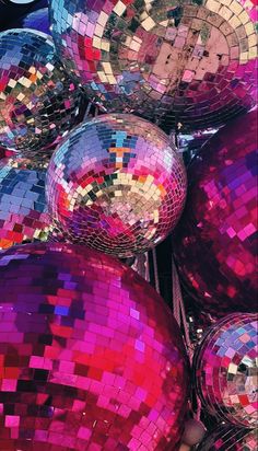 many shiny disco balls are stacked on top of each other