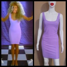 a female mannequin wearing a purple dress and red lipstick on the right side