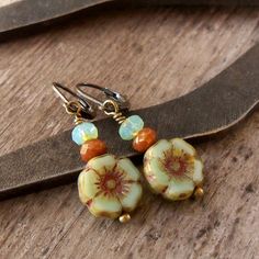 "This listing is for these vintage style, glass beaded, dangle earrings. They are wonderful mint green flower beads, orange brown, and a pale aqua with a touch of green. They are part of my coral pink and mint series. All the items from this series can mix and match. These earrings are 1.5 inches in length. They are light weight and comfortable. The smaller bead is 3 x 5mm in size, the Hibiscus flower bead is 12mm. This is available in a vintage look with antique brass (as shown), hypoallergenic Czech Beads Jewelry, Mint Green Earrings, Crocheted Jewelry, Beaded Jewelry Bracelets, Pink And Mint, Teal Earrings, Earrings Hypoallergenic, Boho Style Earrings, Bead Projects