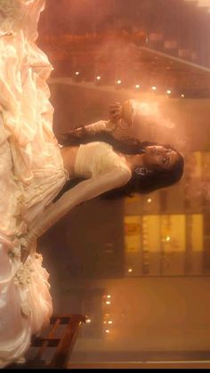 two women dressed in white are dancing on stage