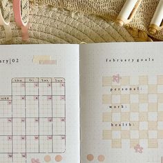 an open calendar book sitting on top of a wicker basket next to some scissors