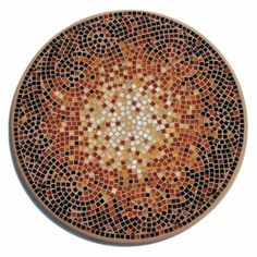 a mosaic plate with an intricate design on the front and back sides, made from small tiles