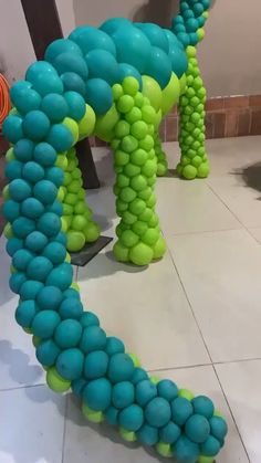 an elephant made out of balloons sitting on the floor