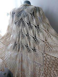 This hand knit shawl cape with lace leaves diversify your dress in boho style, will add a bit of romance to any outfit  * oversized - depth 106 cm. length (neck line)- 208cm( 42'' / 82'' ) * triangle shape * perfect for the winter, autumn, spring and cool summer evening * neutral beige color * different ways of wearing * 100% hand knitted from soft merino wool * gentle hand wash in warm water, drying on a horizontal surface in an extended form * custom order in any color available  I have the same shawl in beige-purple color : https://www.etsy.com/listing/237651676 this shawl in sparkly navy blue here: https://www.etsy.com/listing/666124997 other my shawls for wedding you can see here: https://www.etsy.com/shop/LacyStories?section_id=22735236 Bohemian Open Knit Shawl, Bohemian Hand Knitted Shawl Wrap, Bohemian Hand-knitted Shawl Wrap, One Size Wedding Shawl, One Size Lace Shawl, One Size Open Knit Shawl, One Size Crochet Lace Shawl, Bohemian Cream Knitted Shawl, One Size Cream Knitted Shawl