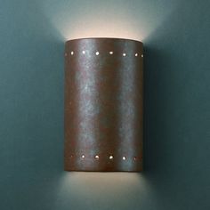 a light that is on the side of a wall in a room with green walls