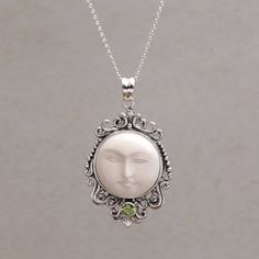 The staring face of a glowing moon is carved by hand of smooth cowbone to center the pendant of this impressive Balinese necklace. Made Wardika presents the necklace which is elaborated with sterling silver designs that surround the moon's face. The pendant is accented with a petite peridot gemstone. Glowing Moon, Peridot Pendant, Bone Pendant, Leather Corded Necklace, Tiffany Jewelry, Moon Pendant Necklace, Printed Jewelry, Turtle Pendant, Peridot Gemstone