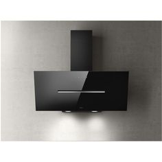 a black wall mounted oven on the side of a gray wall with two lights above it