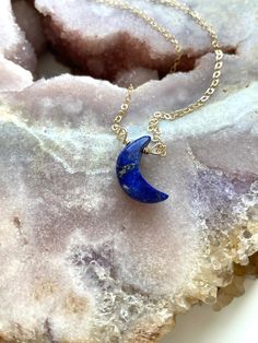 "Stunning 16mm blue Lapis Lazuli Crescent moon pendants have been made into a beautiful crystal necklace. In options of gold or silver this necklace is a show stopper. Perfect gift for that special someone in your life, they will cherish this handmade piece for years to come and will be a luxurious classic necklace to add to their wardrobe. This piece looks great worn alone or layered with other classy pieces. Handcrafted Lapis Lazuli Moon Pendant Necklace *Beautiful gift for her *High quality g Spiritual Blue Moon Necklaces, Sapphire Crystal Necklace For Gift, Blue Spiritual Crystal Necklace With Round Pendant, Spiritual Round Lapis Lazuli Necklace, Blue Lapis Lazuli Crystal Necklace As A Gift, Blue Lapis Lazuli Crystal Necklace - Perfect Gift, Blue Lapis Lazuli Crystal Necklace For Gift, Blue Moon Charm Necklace For Jewelry Making, Blue Moonstone Gemstone Crystal Necklace