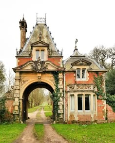 an old brick building with a large archway leading to it