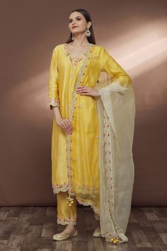 Yellow pure spun silk straight kurta with V neck, butti pattern, border hand embroidered in thread, zari, bead and sequin work. Paired with pants and organza embroidered dupatta.
Component: 3
Pattern: Hand Embroidered
Type Of Work: Thread, Bead, Sequin and Zari Work
Neckline: V Neck
Sleeve Type: Three Quarter Sleeves
Fabric: Pure Spun Silk, Dupatta: Pure Organza
Color: Yellow
Other Details: 
Scalloped cut work hem
Embroidered border on pants
Side slits on kurta
Back placement embroidery
Tasselle Wine Garden, Placement Embroidery, Red Kurta, Straight Fit Pants, Embroidered Border, Embroidered Dupatta, Straight Kurta, Zari Work, Dress Images