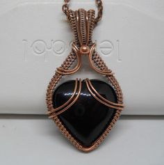 "I made this cute little heart pendant based on a design by Artsville Handcrafted.  The solid black heart is an agate, which has been wrapped in bare copper wire, then oxidized to give it an antique look and to bring out the detail in the wire weave.  It comes on a 19\" oxidized copper chain with lobster clasp. All my items come in a gift box, with free shipping in the US. Thanks so much for stopping by!" Black Heart-shaped Gemstone Jewelry, Handmade Obsidian Jewelry Gift, Black Hand Wrapped Necklace For Gift, Handmade Obsidian Jewelry As A Gift, Hand Wrapped Black Necklace For Gift, Spiritual Black Heart-shaped Necklace, Unique Black Agate Jewelry, Handmade Obsidian Necklaces As Gift, Hand Wrapped Heart Pendant Jewelry Gift